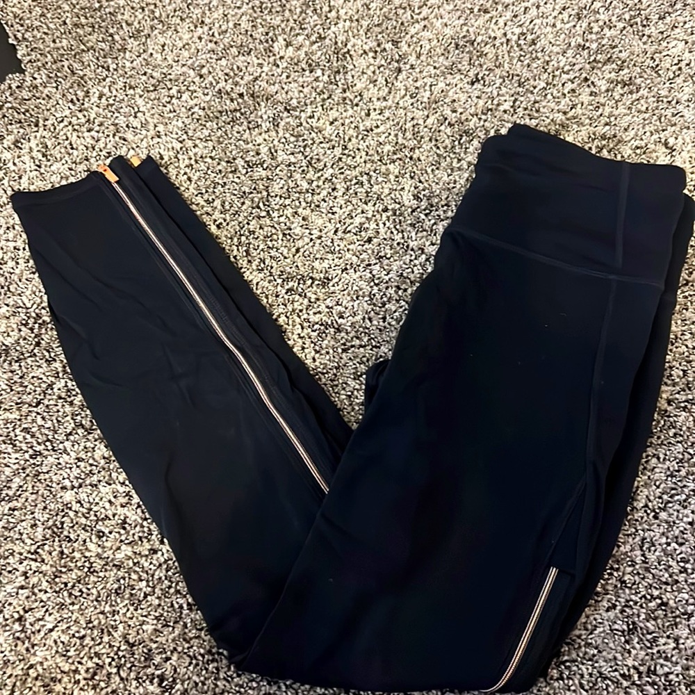 Athleta size small salutation tights. Gold zipper down the sides from knee down